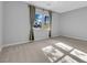 A spacious bedroom featuring two windows with curtains and neutral colored carpet at 380 Baratheon Ave, Las Vegas, NV 89183