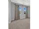 Neutral bedroom with plush carpeting, window views, and elegant drapery at 380 Baratheon Ave, Las Vegas, NV 89183