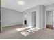 A bedroom with neutral paint and carpet leads to a connected bathroom at 380 Baratheon Ave, Las Vegas, NV 89183
