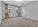 A light bedroom featuring large windows, neutral paint, and carpet at 380 Baratheon Ave, Las Vegas, NV 89183