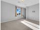 Expansive bonus room with plush carpeting, a large window, and pre-wired connections for a wall-mounted TV at 380 Baratheon Ave, Las Vegas, NV 89183