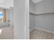 Walk-in closet featuring neutral carpet and walls along with a sturdy closet rod for ample storage at 380 Baratheon Ave, Las Vegas, NV 89183