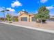 Charming two-story home with a three-car garage, desert landscaping and a beautiful blue sky at 380 Baratheon Ave, Las Vegas, NV 89183
