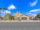 Charming two-story home with a three-car garage, desert landscaping and a beautiful blue sky at 380 Baratheon Ave, Las Vegas, NV 89183