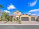 Charming two-story home boasts desert landscaping, a three-car garage, and a paved driveway at 380 Baratheon Ave, Las Vegas, NV 89183