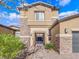 Stylish two-story home with a stone and stucco facade, gated courtyard, and well-maintained landscaping at 380 Baratheon Ave, Las Vegas, NV 89183
