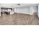 Bright living area with wood-look tile floors, stylish lighting, and neutral wall color at 380 Baratheon Ave, Las Vegas, NV 89183