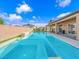 A sparkling pool with sun shelf and modern design is the perfect backyard oasis at 380 Baratheon Ave, Las Vegas, NV 89183
