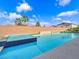 Luxury backyard pool featuring raised spa, sun shelf, and modern design elements at 380 Baratheon Ave, Las Vegas, NV 89183