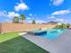 Backyard pool with turf and brick privacy wall creates a luxurious oasis at 380 Baratheon Ave, Las Vegas, NV 89183