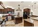 Kitchen featuring granite counters, dark cabinets, and stainless steel appliances at 3823 Chapels Royal St, Laughlin, NV 89029