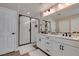 Modern bathroom featuring double sinks, sleek black fixtures, and a glass-enclosed shower with bright white tiling at 3921 Painted Lady Ave, Las Vegas, NV 89141