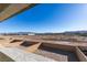 Unobstructed desert view from a balcony, featuring a mix of sandy terrain and distant mountain ranges under a blue sky at 3921 Painted Lady Ave, Las Vegas, NV 89141