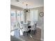 Bright dining area featuring a glass table, comfortable chairs, and sliding glass doors to the backyard at 3921 Painted Lady Ave, Las Vegas, NV 89141