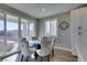 Dining area with modern table and chairs, patio access, and a view to the backyard at 3921 Painted Lady Ave, Las Vegas, NV 89141