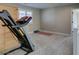 Exercise room with carpet flooring, fitness equipment, and a shuttered window at 3921 Painted Lady Ave, Las Vegas, NV 89141