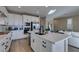 Modern kitchen features white cabinets, stainless steel appliances, and a center island with a sink at 3921 Painted Lady Ave, Las Vegas, NV 89141