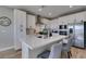 Bright kitchen features white cabinets, stainless steel appliances, and a large center island with seating at 3921 Painted Lady Ave, Las Vegas, NV 89141