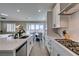 Bright kitchen featuring white cabinets, stainless steel appliances, and seamless access to a dining area at 3921 Painted Lady Ave, Las Vegas, NV 89141