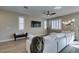 Large living area with a sprawling sectional, stylish lighting fixtures, and views of the backyard, inviting relaxation at 3921 Painted Lady Ave, Las Vegas, NV 89141