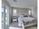 Comfortable main bedroom with soft, neutral tones, a king bed, and balcony access for a tranquil retreat at 3921 Painted Lady Ave, Las Vegas, NV 89141