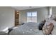 Bright main bedroom with a sliding glass door leading to a balcony showcasing views of the surrounding desert landscape at 3921 Painted Lady Ave, Las Vegas, NV 89141