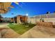 Well-maintained backyard with artificial turf, brick pathway, patio and cozy gazebo seating area at 4055 Planetary Ln, Las Vegas, NV 89115