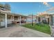 Expansive backyard with a covered patio, backyard gazebo, and pristine artificial turf at 4055 Planetary Ln, Las Vegas, NV 89115