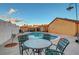 A spacious backyard with a pool and a dining set, ideal for outdoor entertaining and summer relaxation at 4055 Planetary Ln, Las Vegas, NV 89115