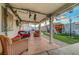 Inviting backyard retreat featuring a covered patio, comfortable seating, and lush artificial turf at 4055 Planetary Ln, Las Vegas, NV 89115