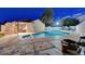 Spacious backyard with a refreshing pool, covered patio, and lounge area for outdoor relaxation and entertainment at 4055 Planetary Ln, Las Vegas, NV 89115