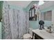 A bathroom featuring modern vanity, framed mirror, and a patterned shower curtain at 4055 Planetary Ln, Las Vegas, NV 89115