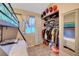 Bright bedroom featuring a bunk bed, closet with shelves, and natural light at 4055 Planetary Ln, Las Vegas, NV 89115