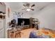 Bedroom featuring a ceiling fan, desk, large television, and window at 4055 Planetary Ln, Las Vegas, NV 89115