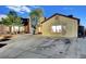 Back exterior view of a single-story home with a large driveway at 4055 Planetary Ln, Las Vegas, NV 89115