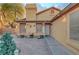 Charming single-story home with a welcoming facade, desert landscaping, and a unique brick driveway at 4055 Planetary Ln, Las Vegas, NV 89115