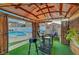 Cozy gazebo setup with a high-top table, a transparent cooler, and a view of the inviting pool area at 4055 Planetary Ln, Las Vegas, NV 89115