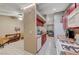 Bright kitchen with red cabinets and views into the living area at 4055 Planetary Ln, Las Vegas, NV 89115