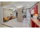 Open-concept kitchen and living area with tile flooring and cozy seating at 4055 Planetary Ln, Las Vegas, NV 89115