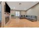 Comfortable living room showcases a fireplace, hardwood floors, and a cozy sectional sofa at 4055 Planetary Ln, Las Vegas, NV 89115