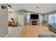 Open-concept living room featuring hardwood floors, fireplace, and easy access to other living spaces at 4055 Planetary Ln, Las Vegas, NV 89115