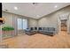 Inviting living room with a plush sectional, hardwood flooring, and natural light from the window at 4055 Planetary Ln, Las Vegas, NV 89115