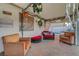 Charming covered patio with cozy seating, decor, and views of the pool area at 4055 Planetary Ln, Las Vegas, NV 89115