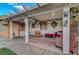 Relaxing covered patio area complete with comfortable seating and decorative accents at 4055 Planetary Ln, Las Vegas, NV 89115