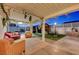 Inviting covered patio area, decorated with cozy seating, lighting and views of the backyard, and pool at 4055 Planetary Ln, Las Vegas, NV 89115