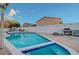 A sparkling in-ground pool offers a refreshing oasis in the backyard, perfect for summer fun and relaxation at 4055 Planetary Ln, Las Vegas, NV 89115