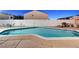 Large backyard pool surrounded by concrete patio, offering plenty of space for summer fun at 4055 Planetary Ln, Las Vegas, NV 89115