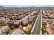 An aerial view showcases a tidy residential area with uniform rooftops, manicured lawns, and a distant city view at 4141 Coburn St, North Las Vegas, NV 89032