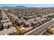 An aerial view captures a neighborhood with well-maintained streets, beautiful homes, and a glimpse of the city skyline at 4141 Coburn St, North Las Vegas, NV 89032