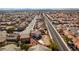 An aerial image exhibits an orderly neighborhood with cozy houses, quiet streets, and urban views in the background at 4141 Coburn St, North Las Vegas, NV 89032